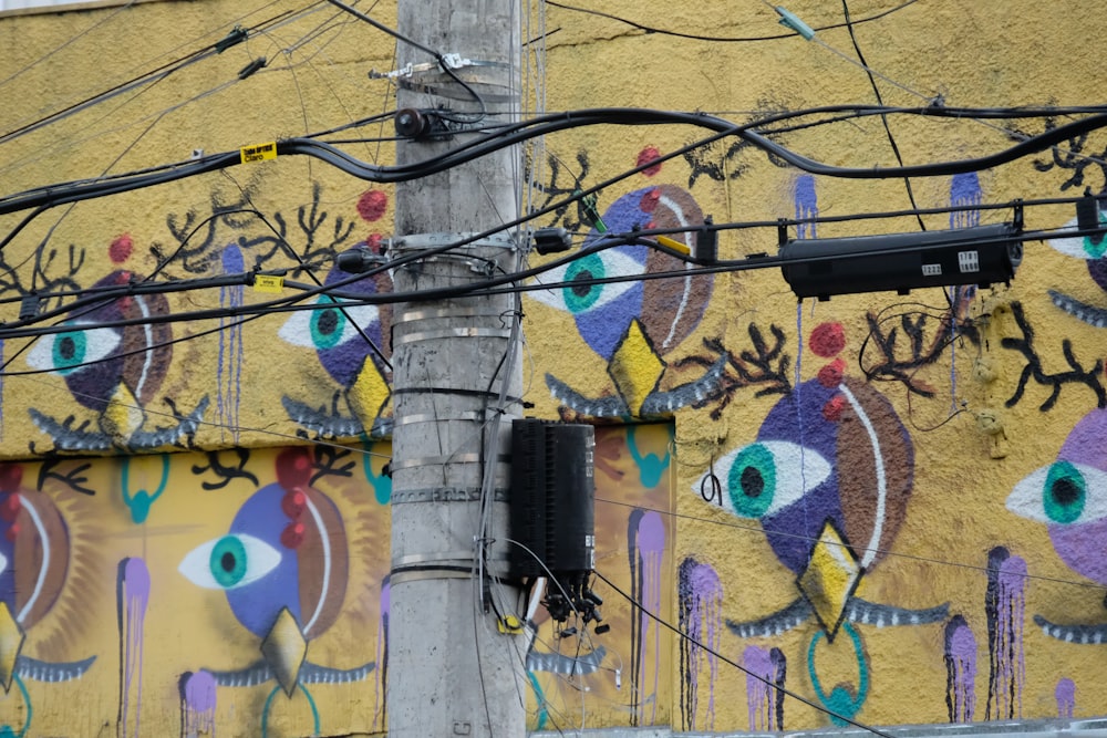 a yellow building with a colorful mural on it's side