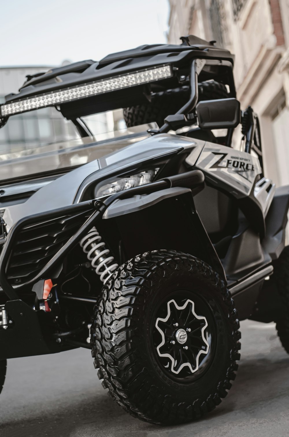 a black four wheeled vehicle parked on the street