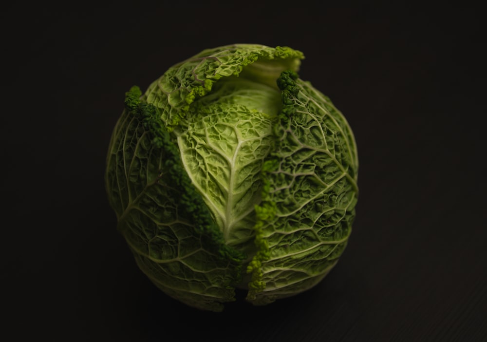 a head of cabbage on a black background