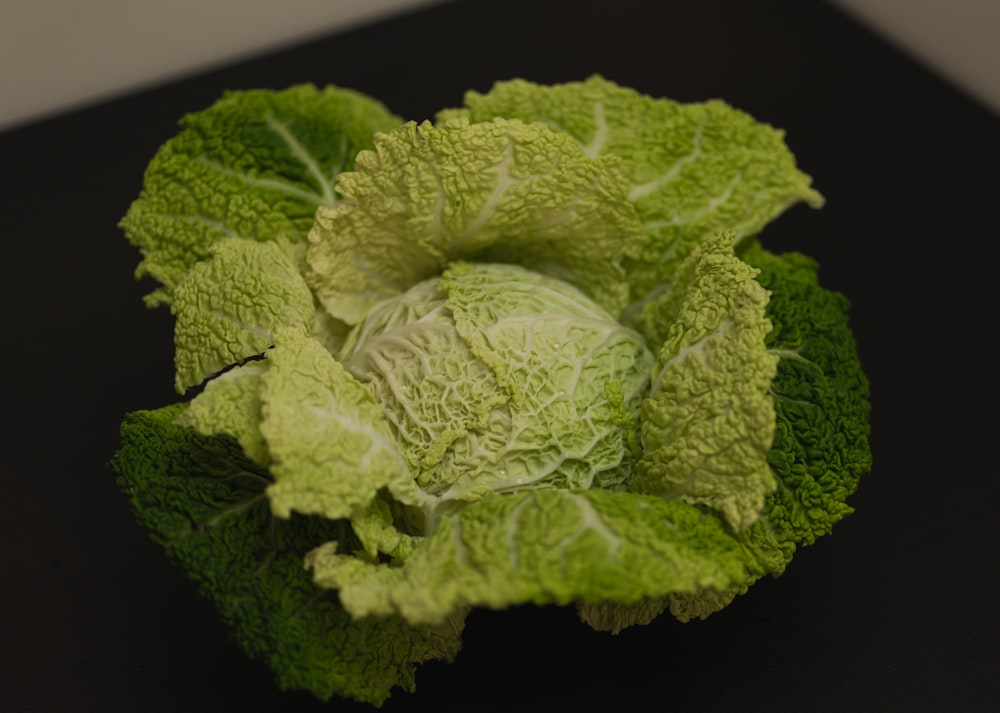 a head of broccoli on a black surface