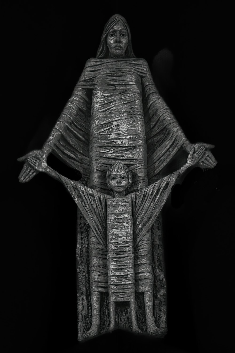 a black and white photo of a statue of jesus