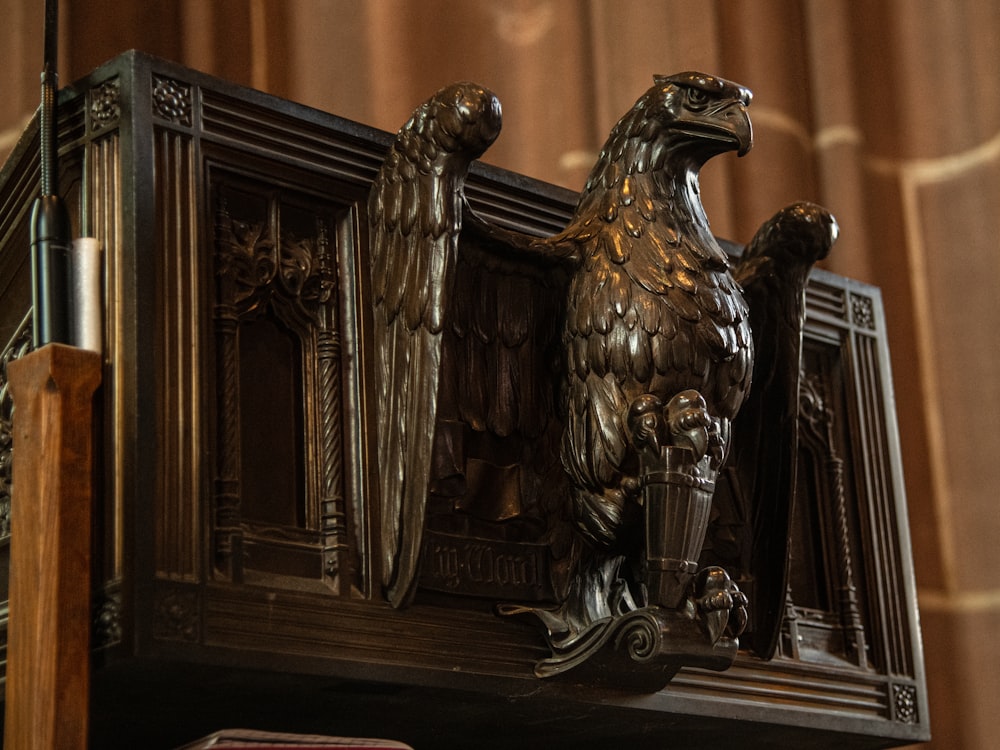 a statue of an eagle on top of a mantle