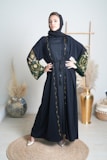 A beautiful black abaya displayed on a mannequin.