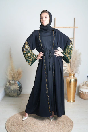 A serene portrait of a woman wearing a flowing abaya in soft natural light, embodying grace and confidence.