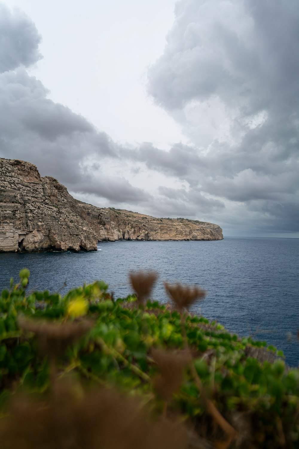 a body of water with a cliff in the background