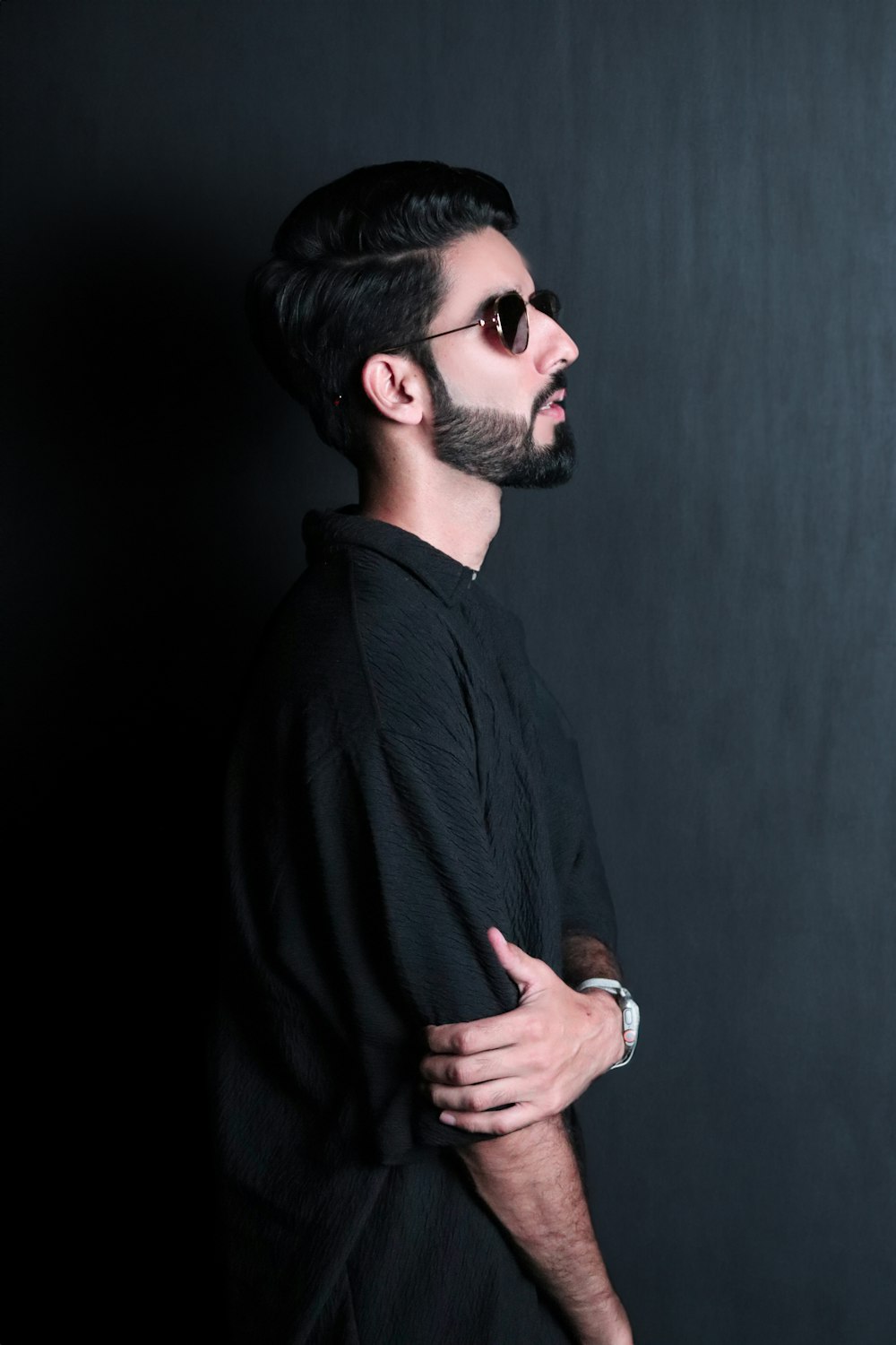 a man with a beard wearing sunglasses and a black shirt