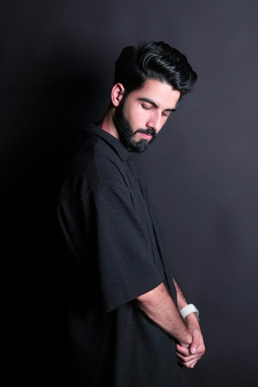 a man with a beard wearing a black shirt