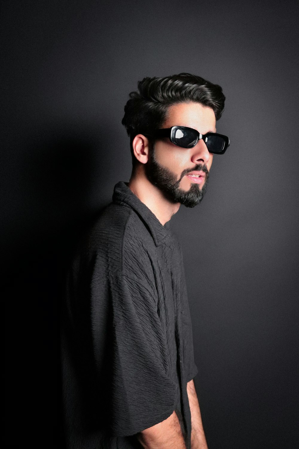 a man wearing sunglasses and a black shirt