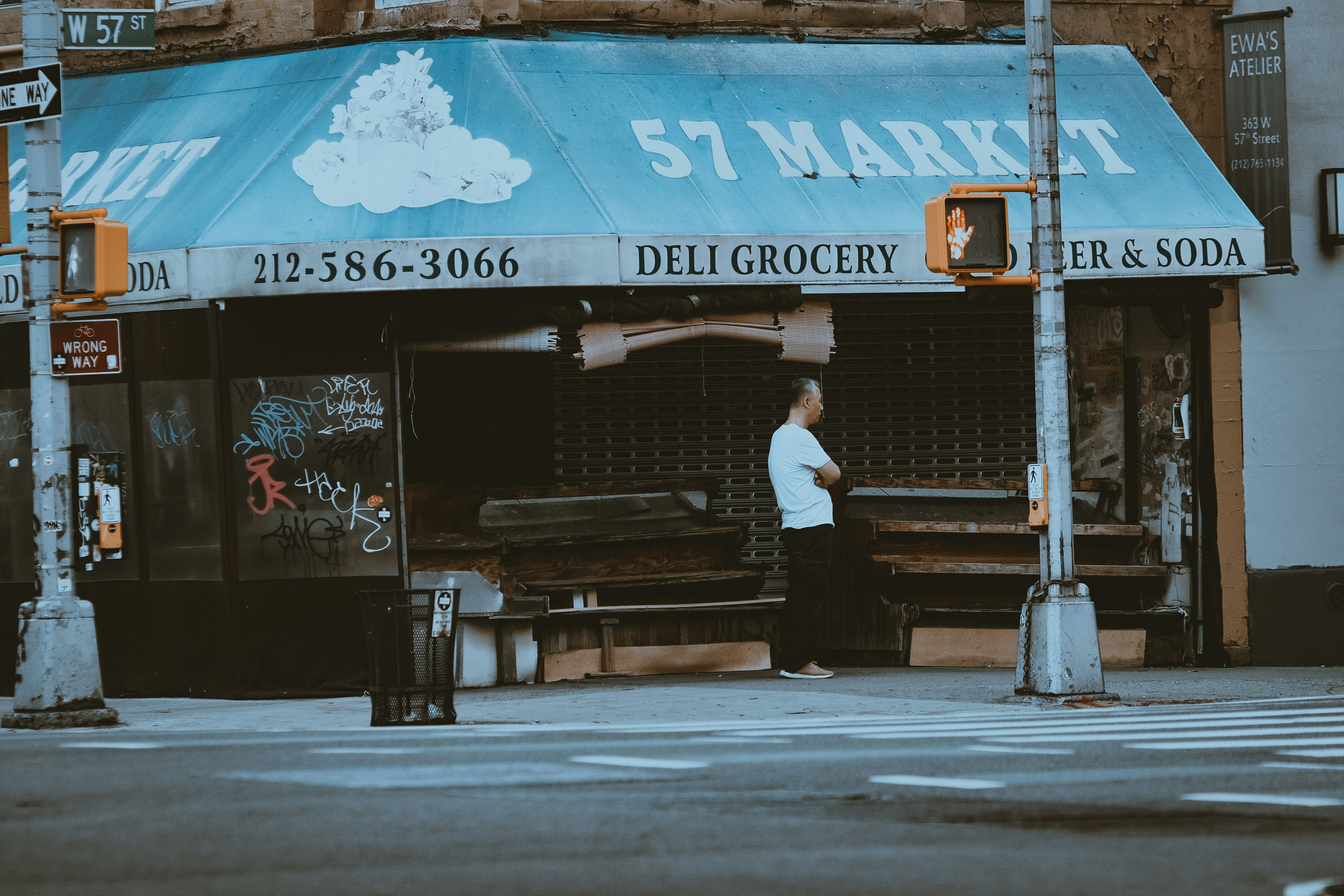 a man standing in front of a store on a city street