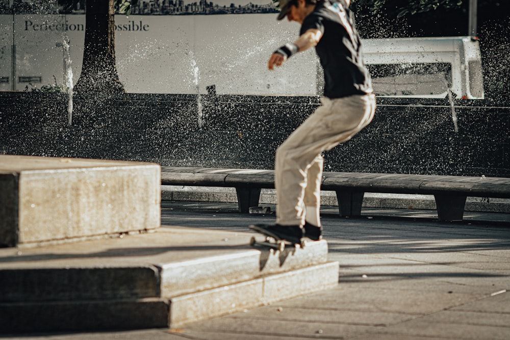 a man riding a skateboard down the side of a cement block