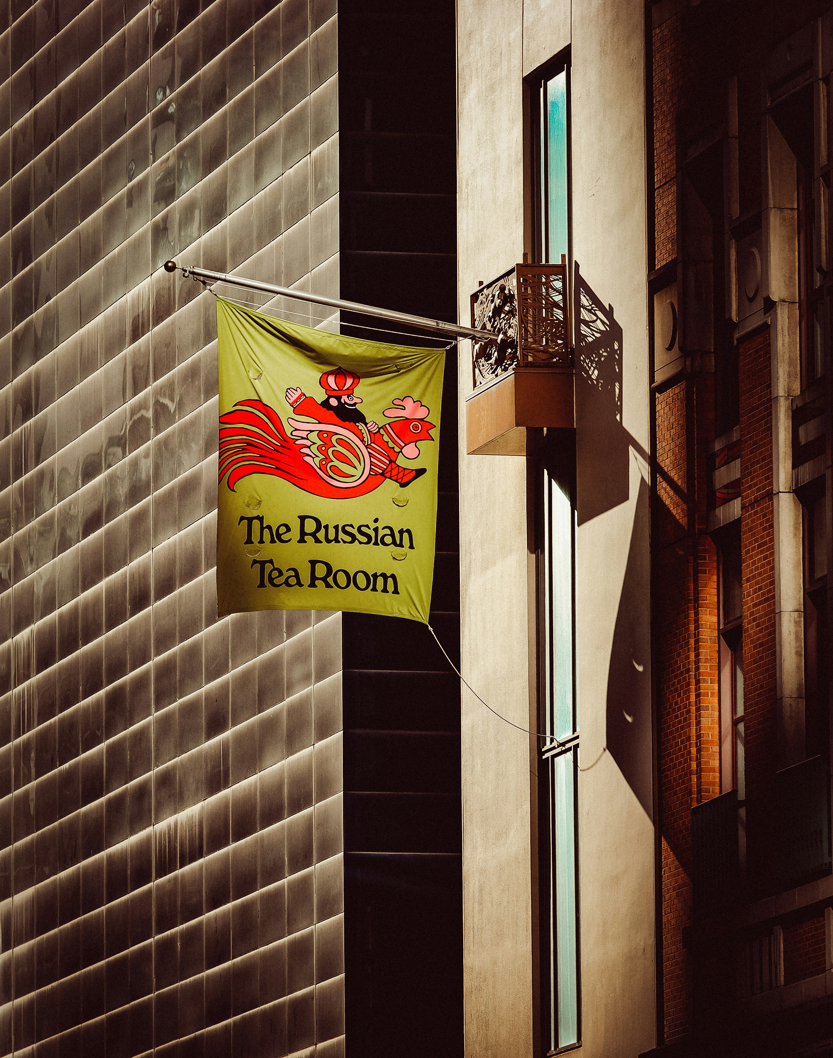 a russian tea room sign hanging from the side of a building