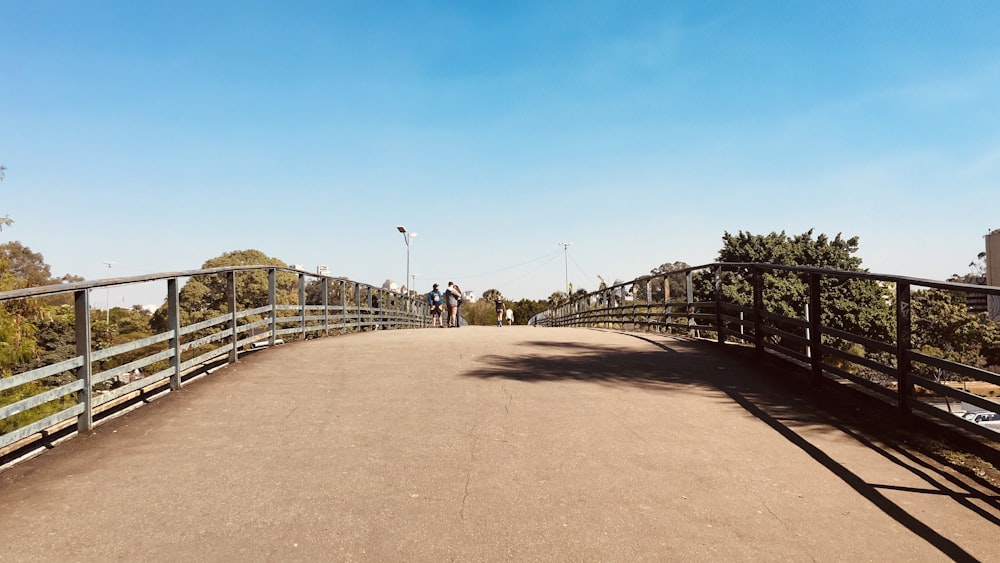 a man riding a skateboard across a bridge