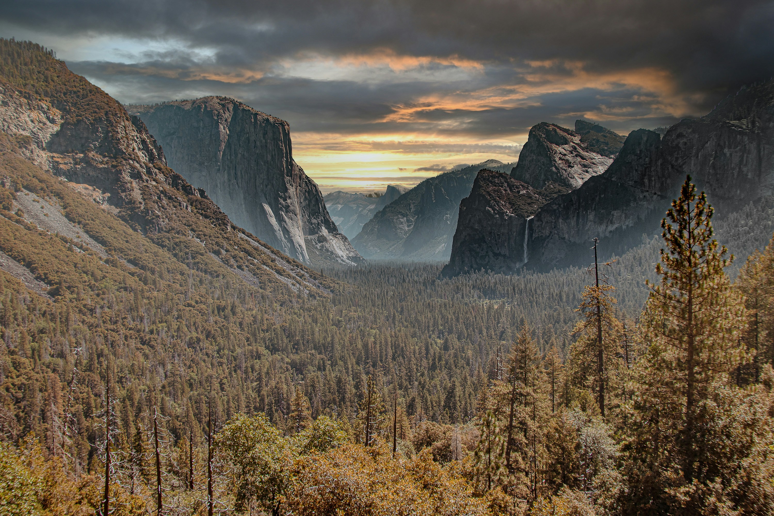 a view of a valley with mountains in the background