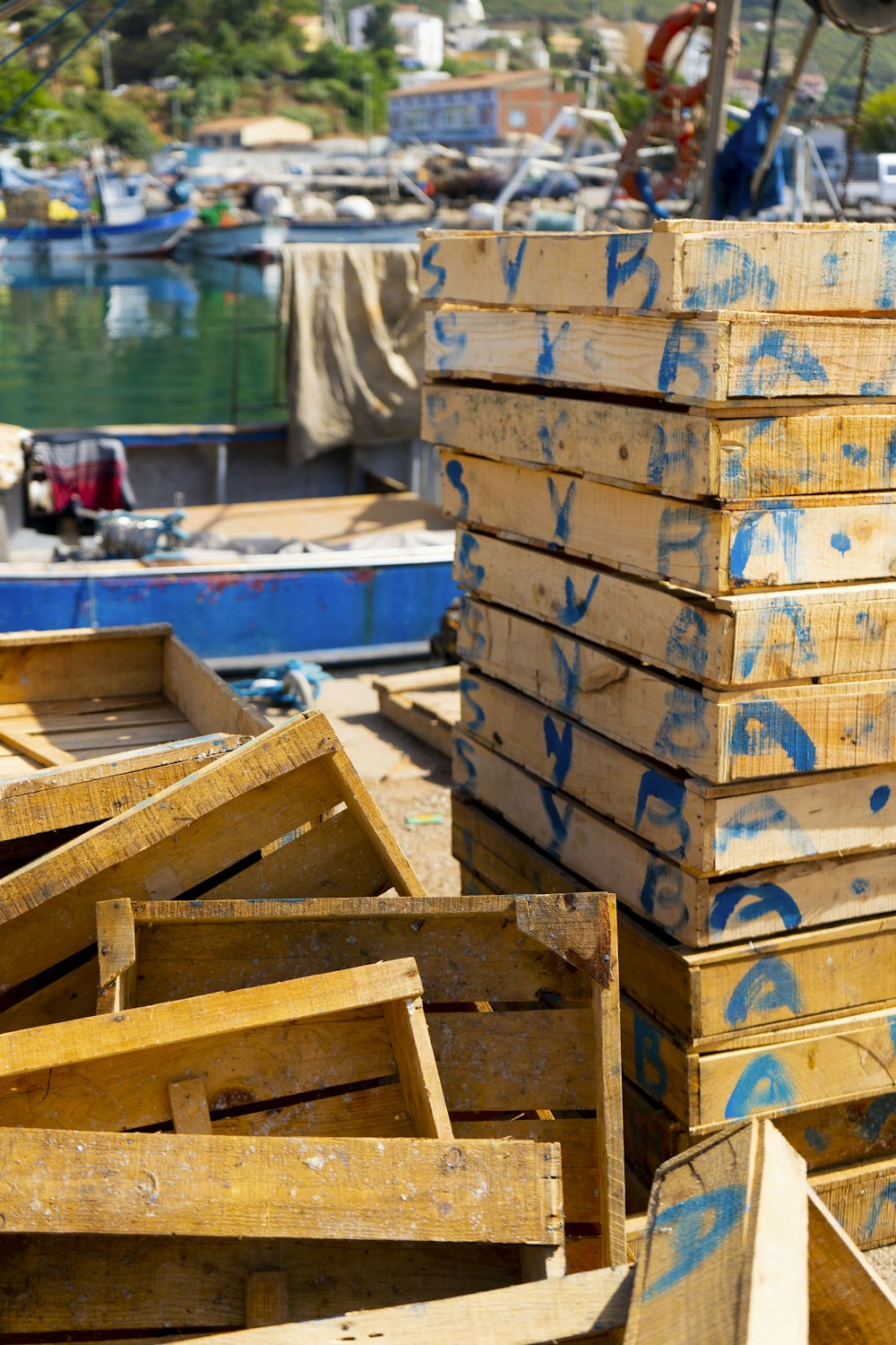 a pile of wooden crates sitting on top of a dock