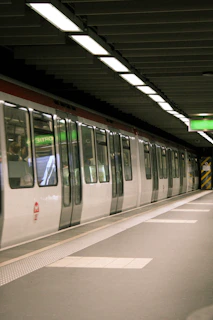 Avelina Horizon subway train arriving at a spacious underground station with modern lighting and clear signage.