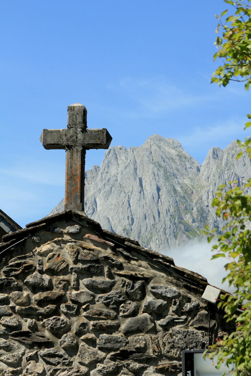 a stone building with a cross on top of it