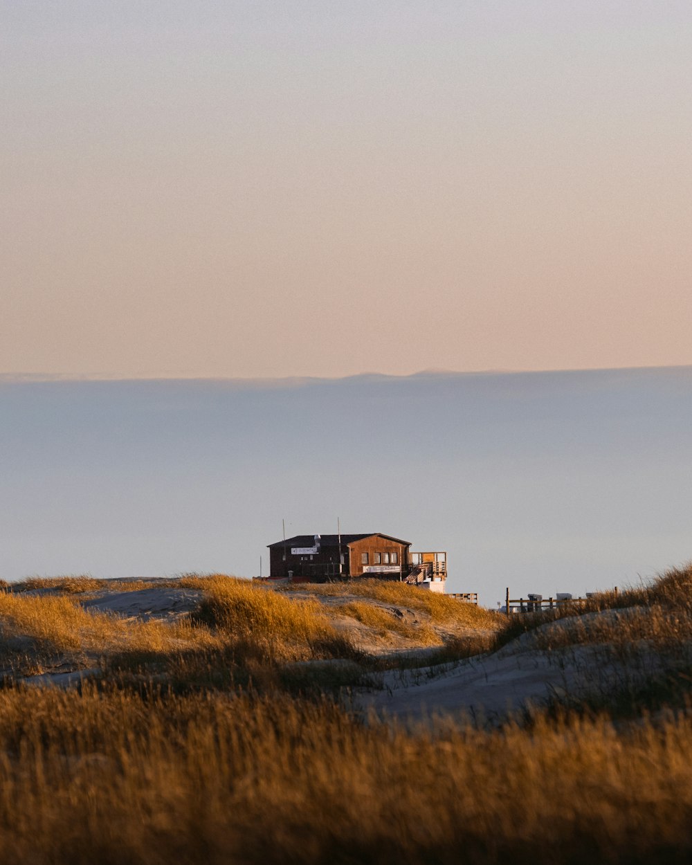 a house on a hill with a sky in the background