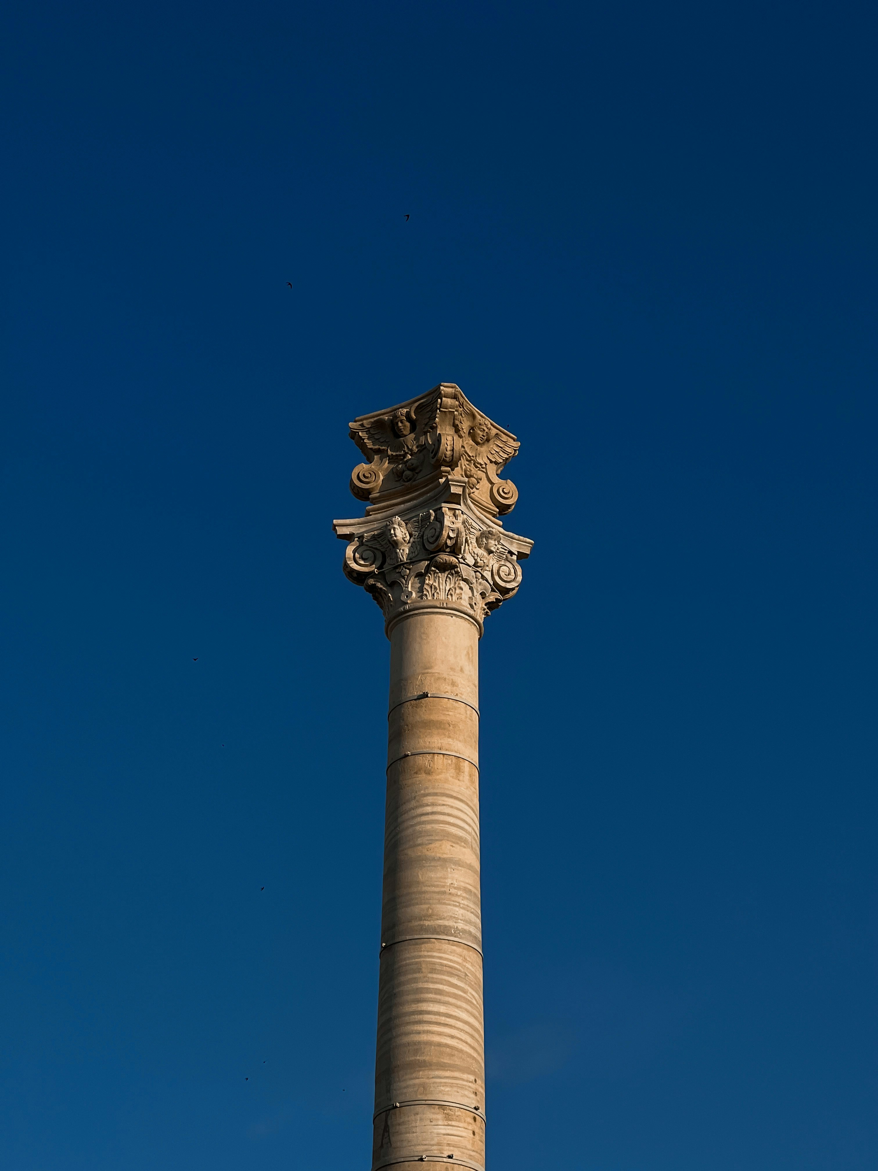 a tall pillar with a statue on top of it
