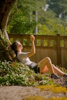 Urban young adult enjoying fresh Pandafruit fruit in a city park setting