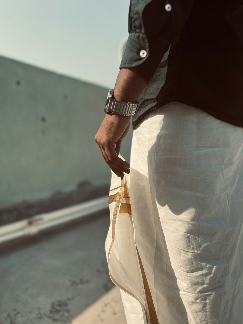 a man is holding a bag on the side of the road