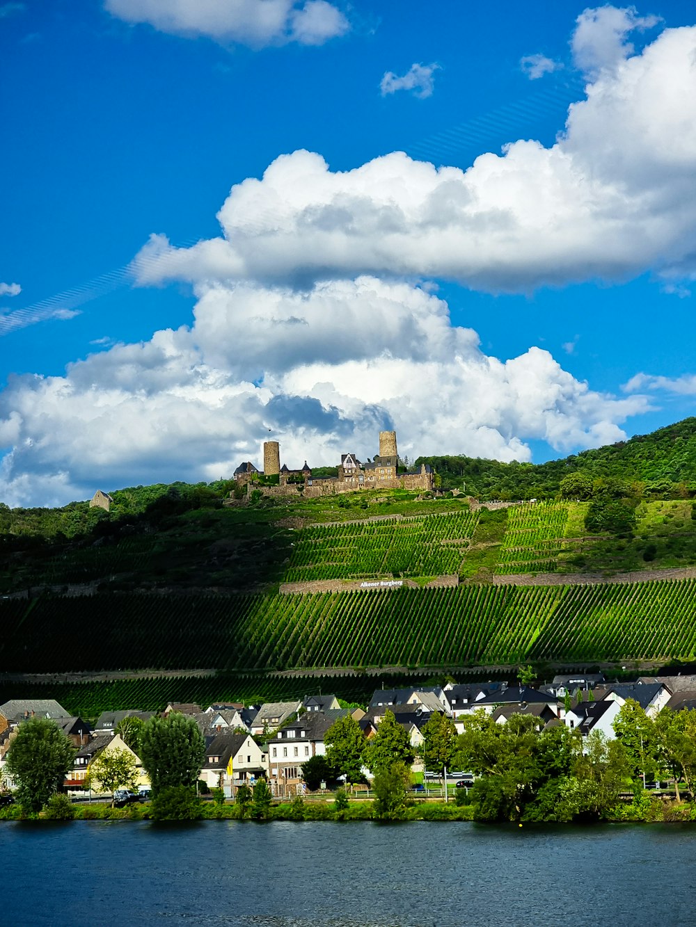 a scenic view of a village and a river