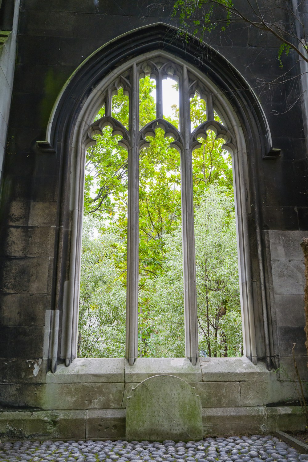 a stone bench in front of a large window