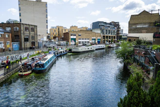 a river running through a city next to tall buildings