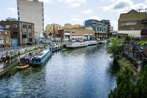 a river running through a city next to tall buildings