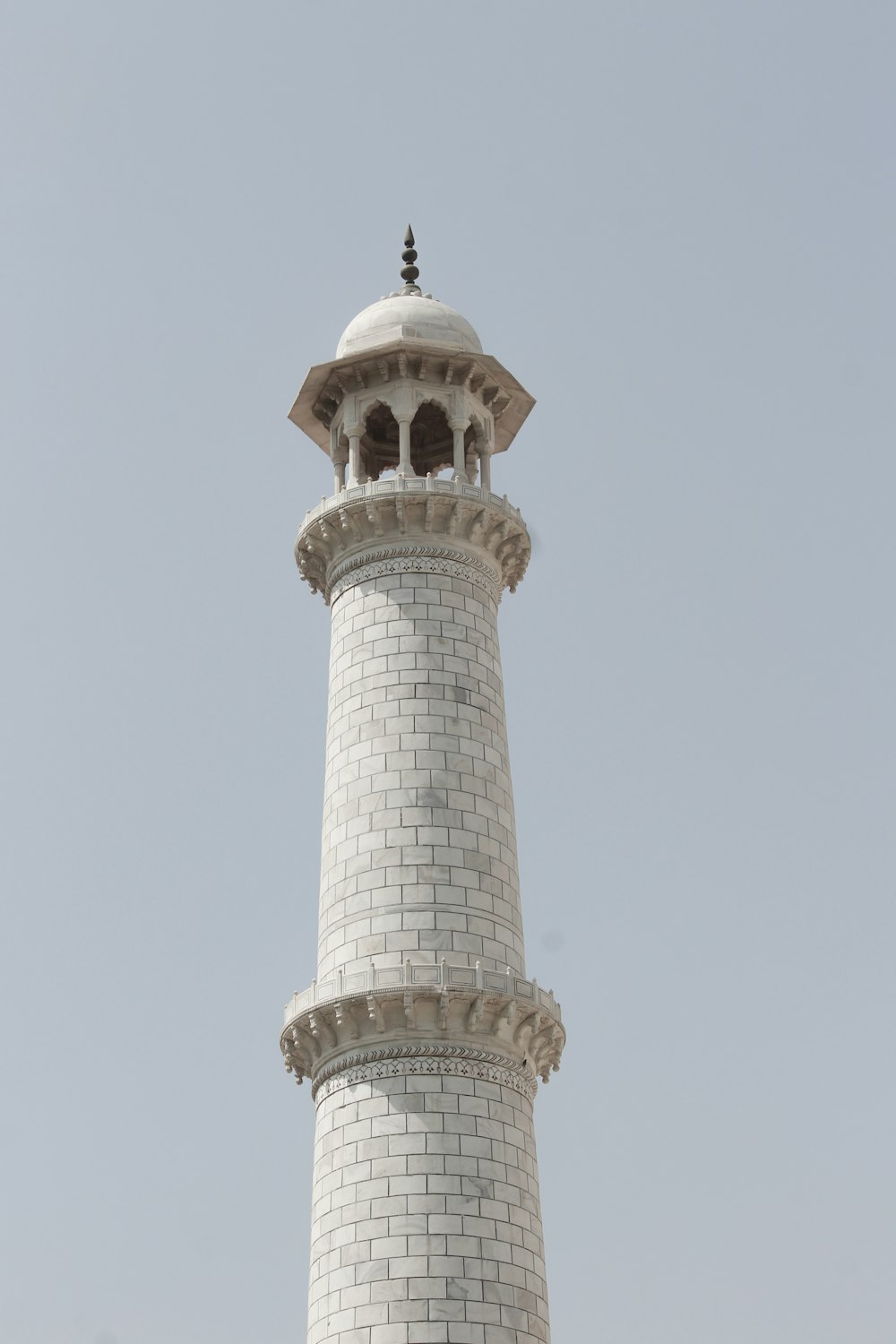 a tall white tower with a clock on top