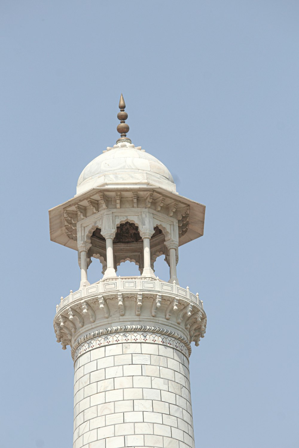 a white tower with a clock on the top of it
