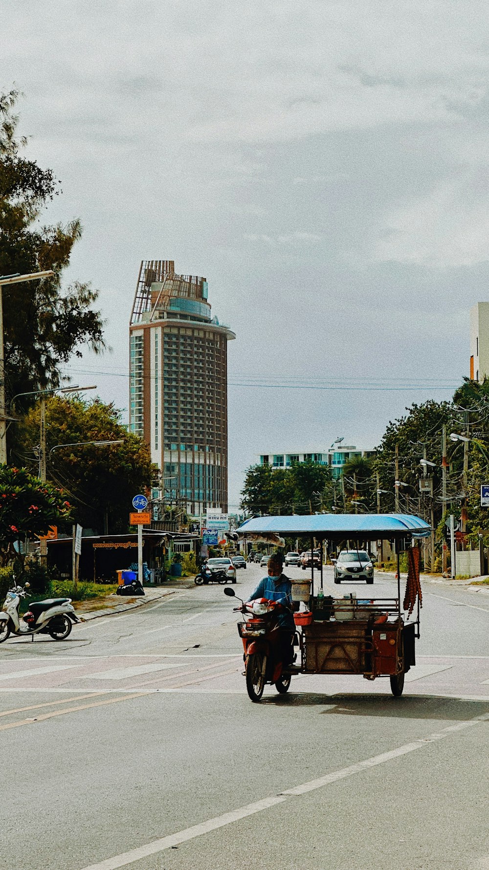 a man driving a cart on a city street
