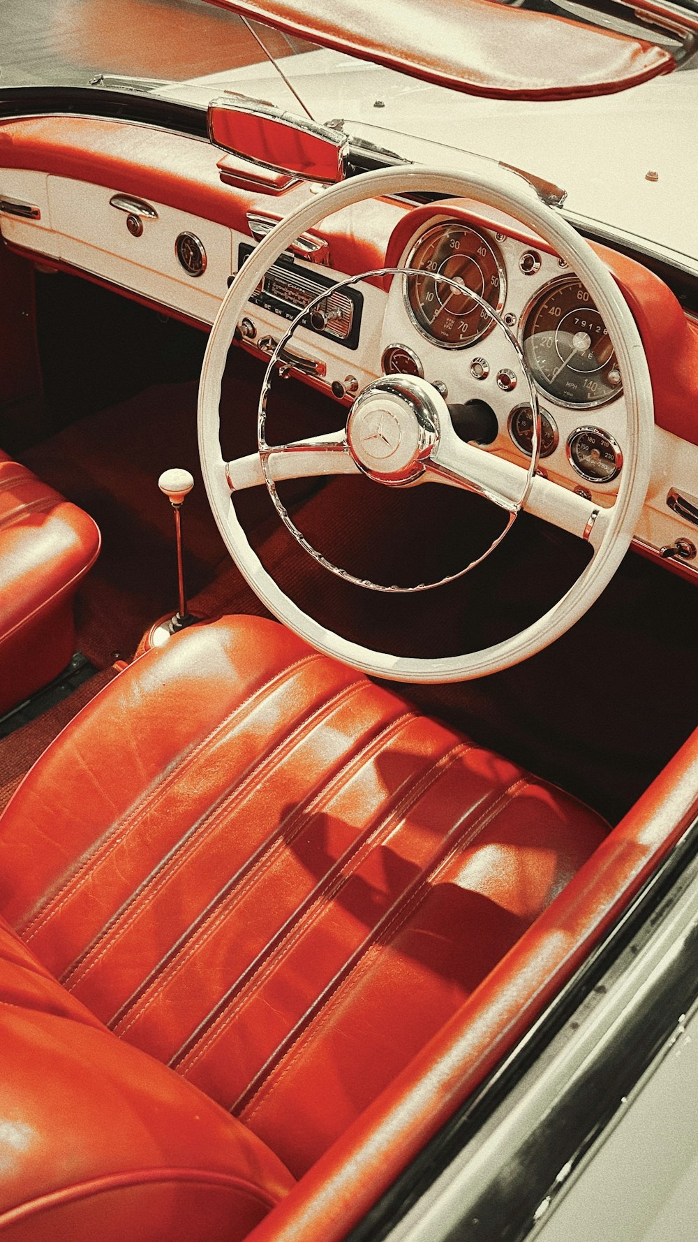 the interior of a car with a steering wheel and dashboard