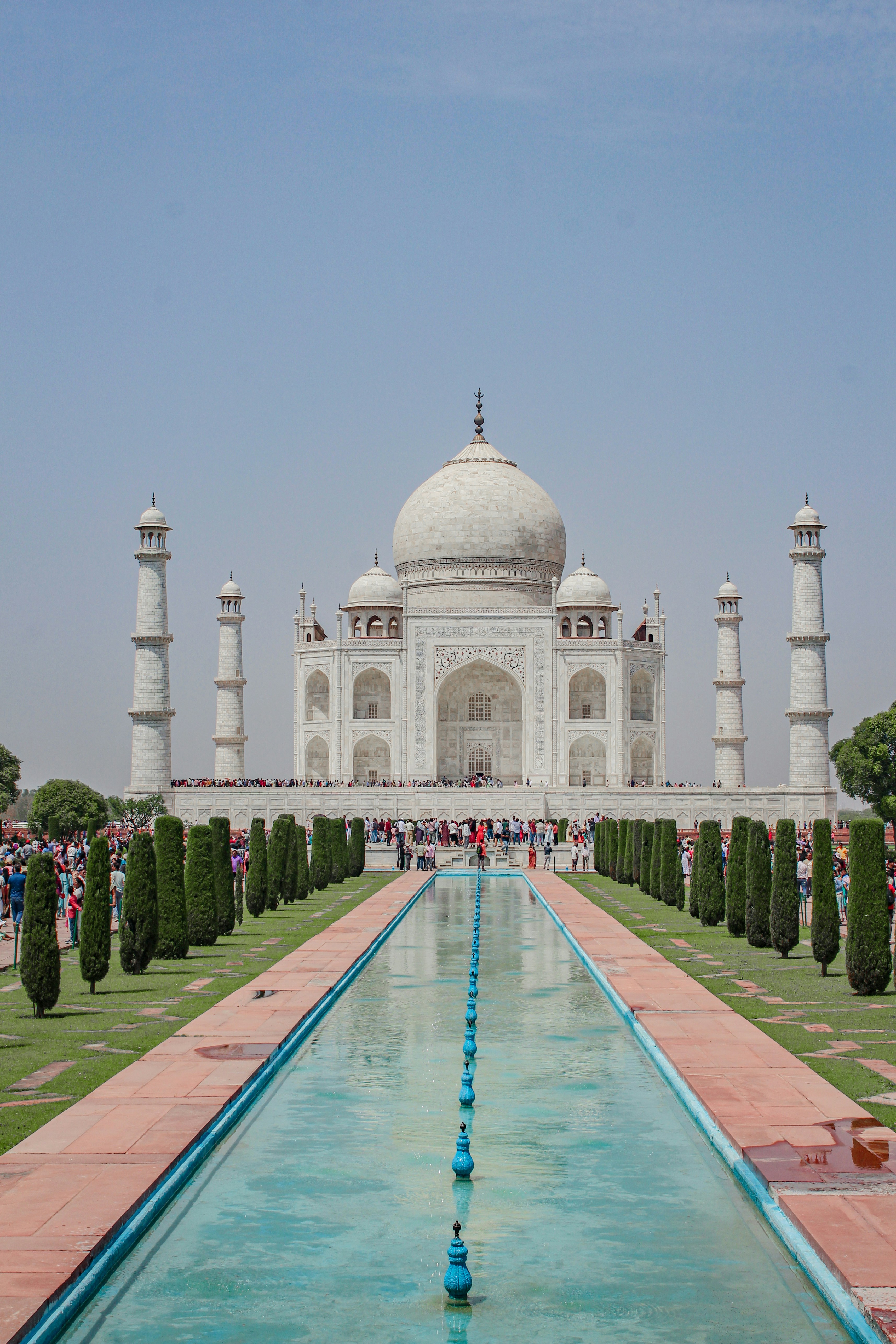 a large white building with a fountain in front of it