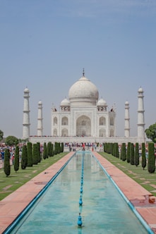 a large white building with a fountain in front of it