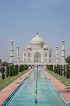 a large white building with a fountain in front of it