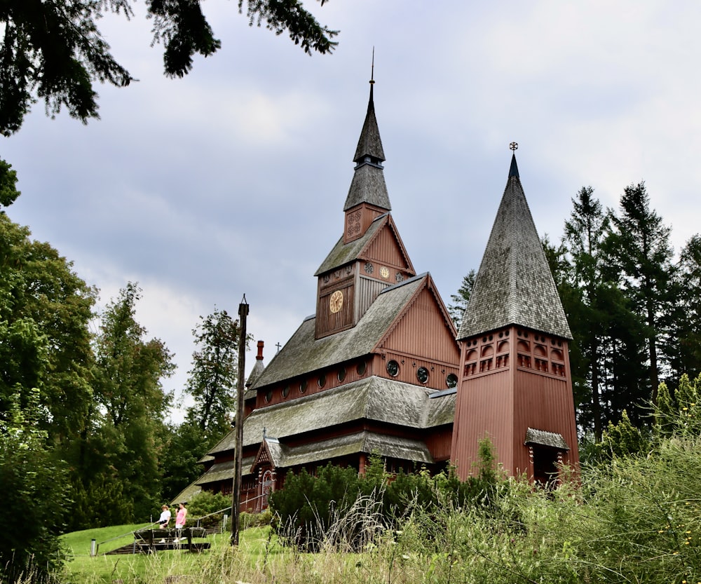 a large red building with two towers and a clock