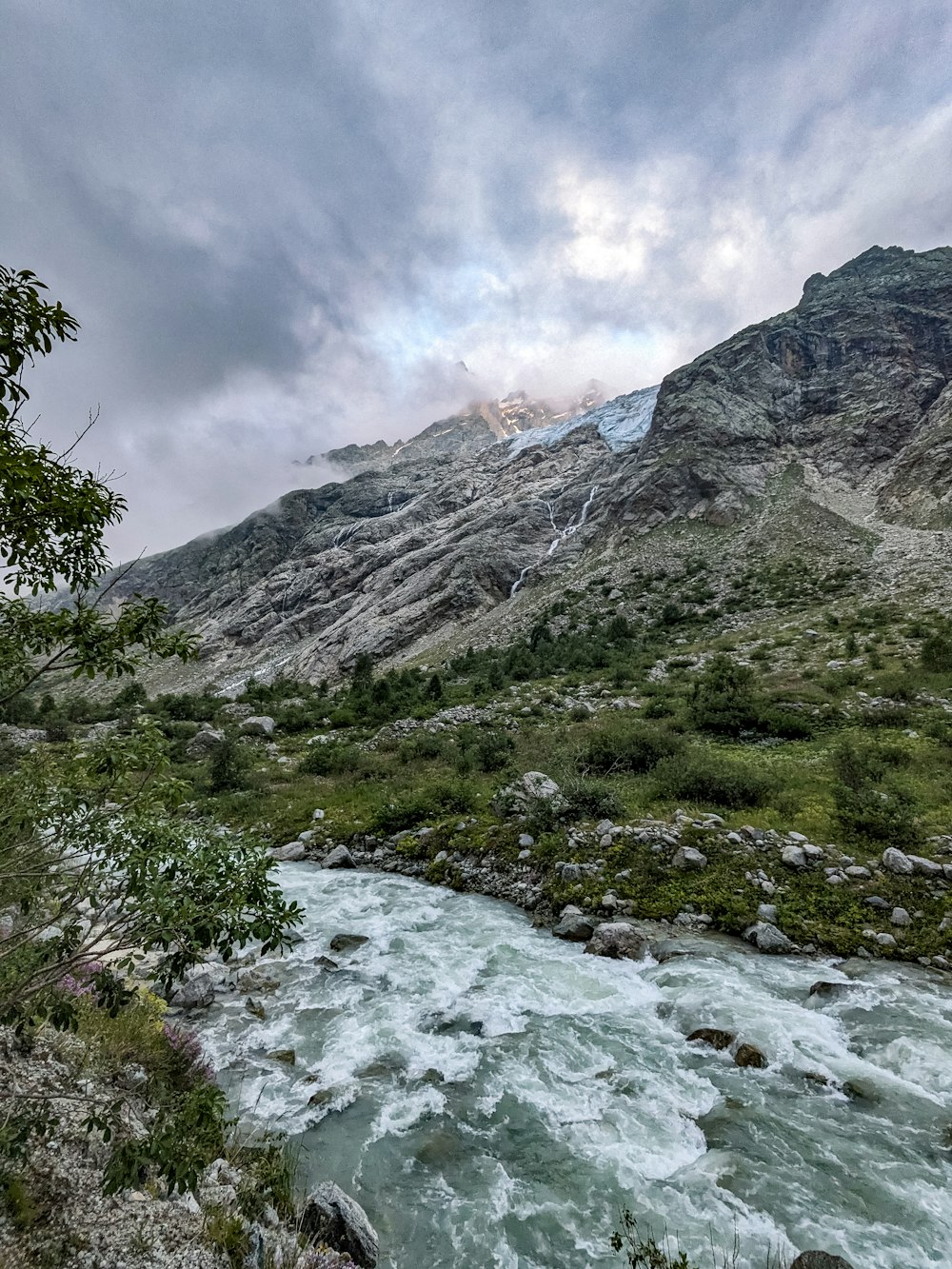 a river running through a lush green valley