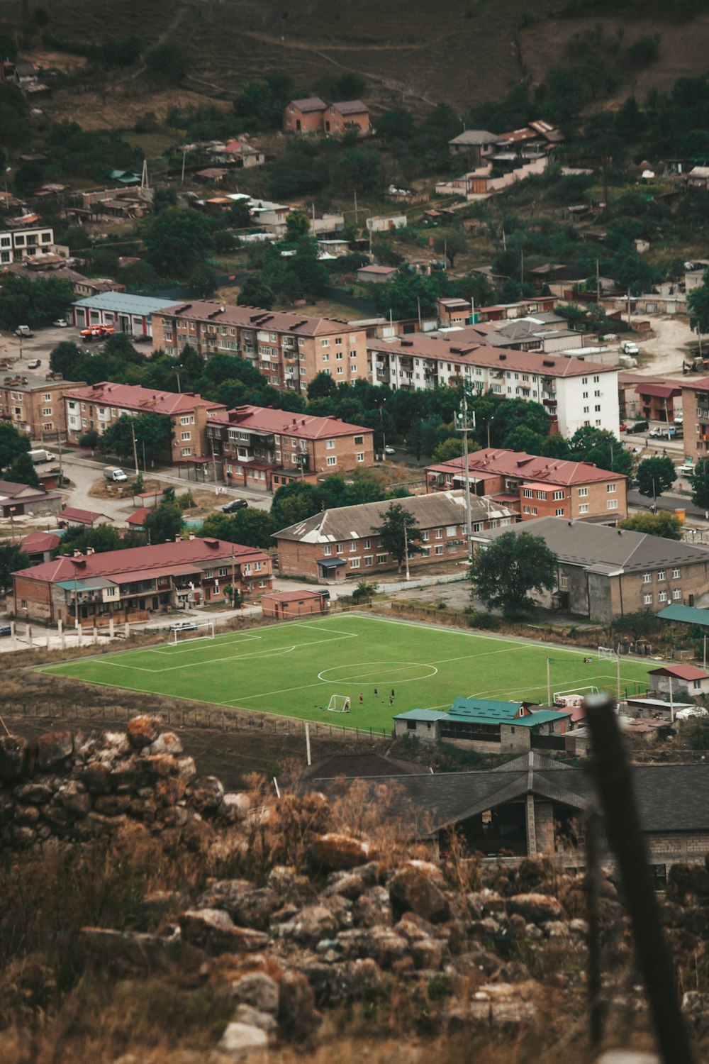 a view of a soccer field from a hill