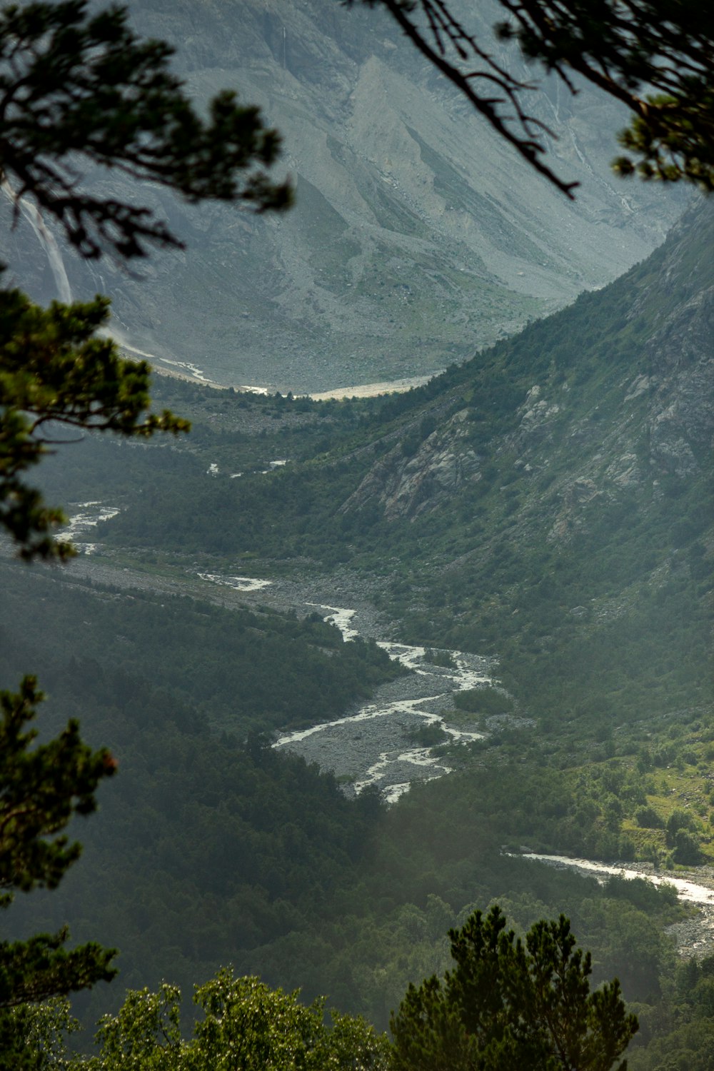 a view of a valley with a river running through it