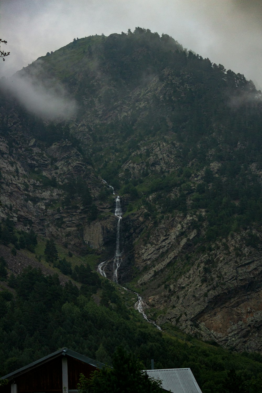 a mountain with a waterfall in the middle of it