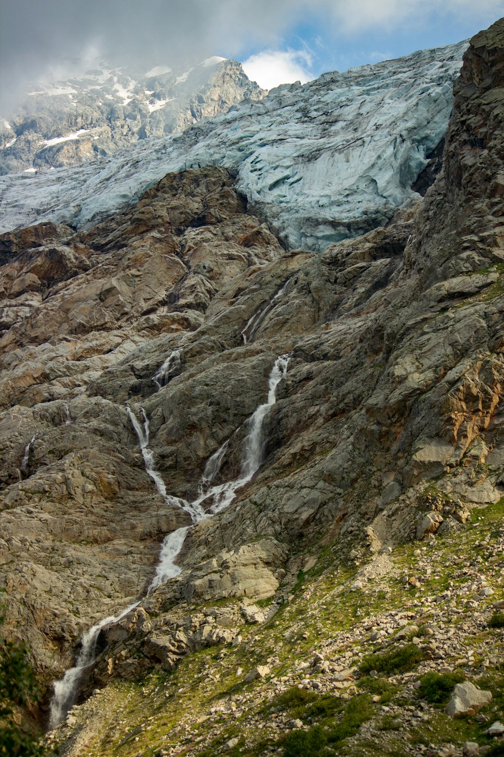 a mountain with a waterfall running down it's side