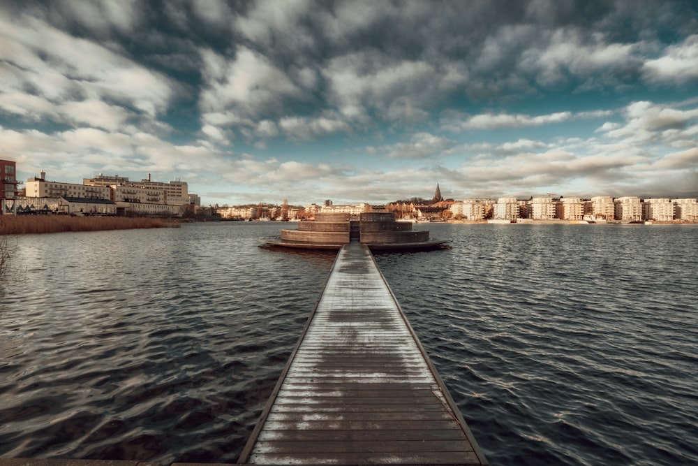 a long dock sitting in the middle of a body of water