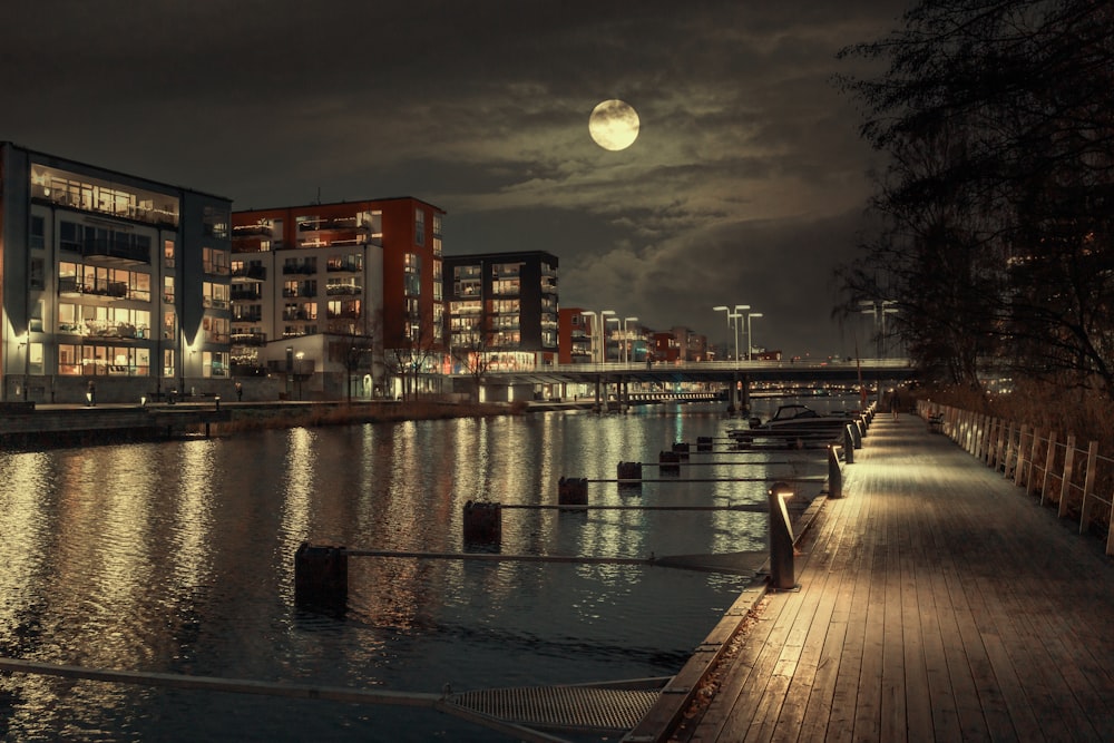 a full moon is seen over a city at night