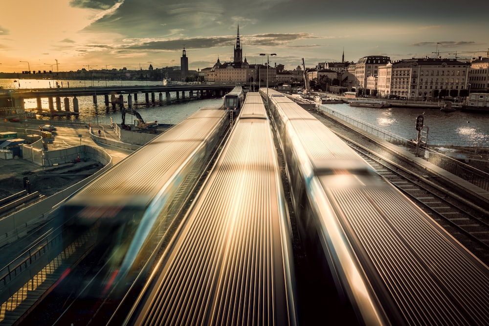 a train traveling down train tracks next to a body of water