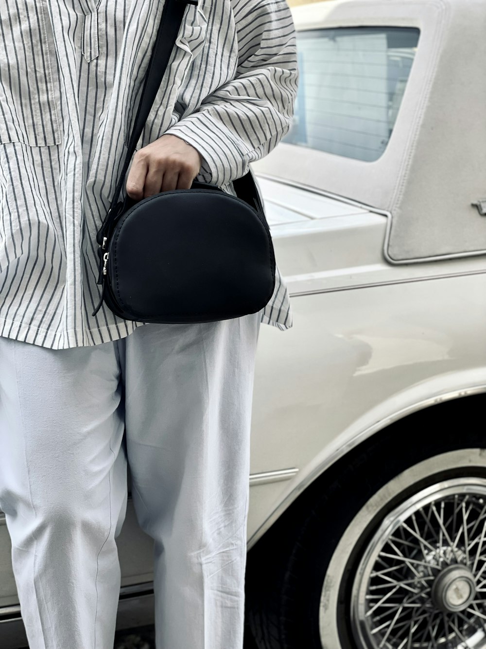 a man standing next to a white car