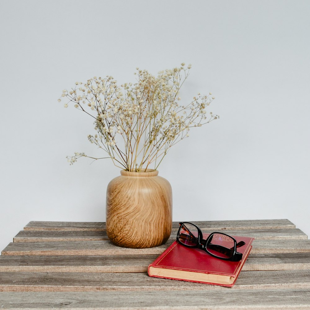 a pair of glasses sitting on top of a wooden table