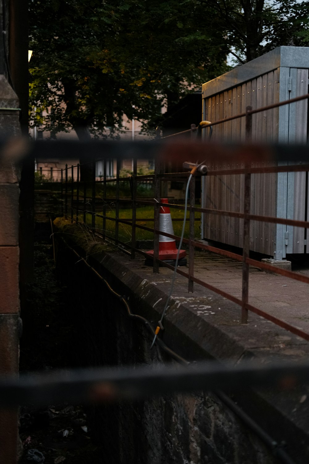 a red and white fire hydrant sitting next to a building