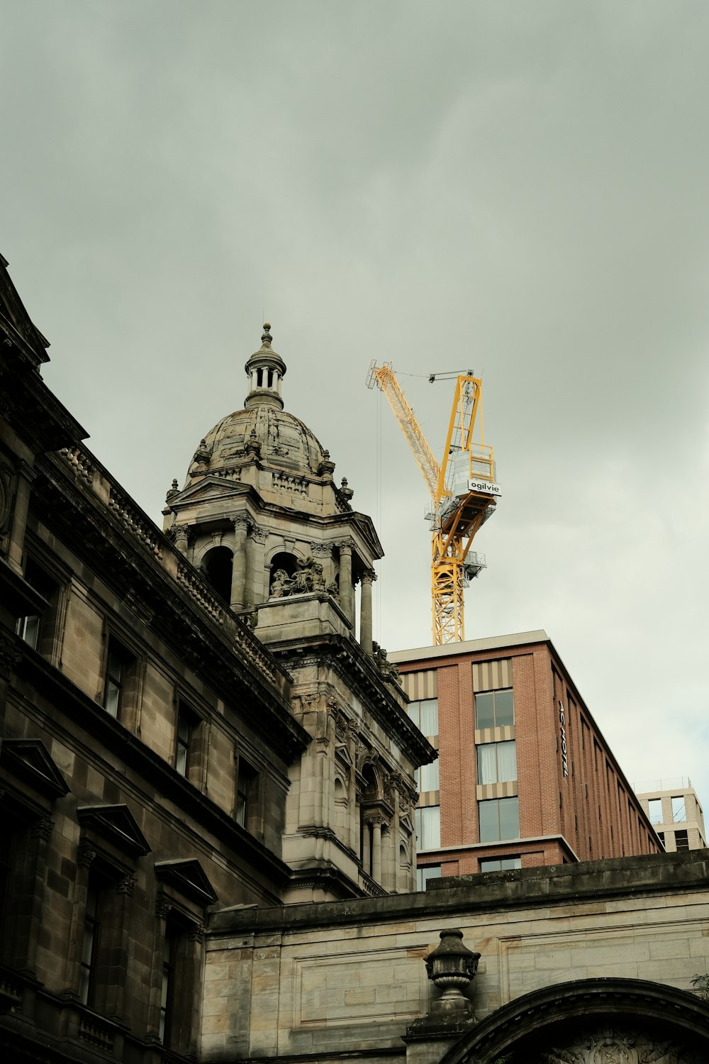 un grand bâtiment surmonté d’une tour et d’une grue