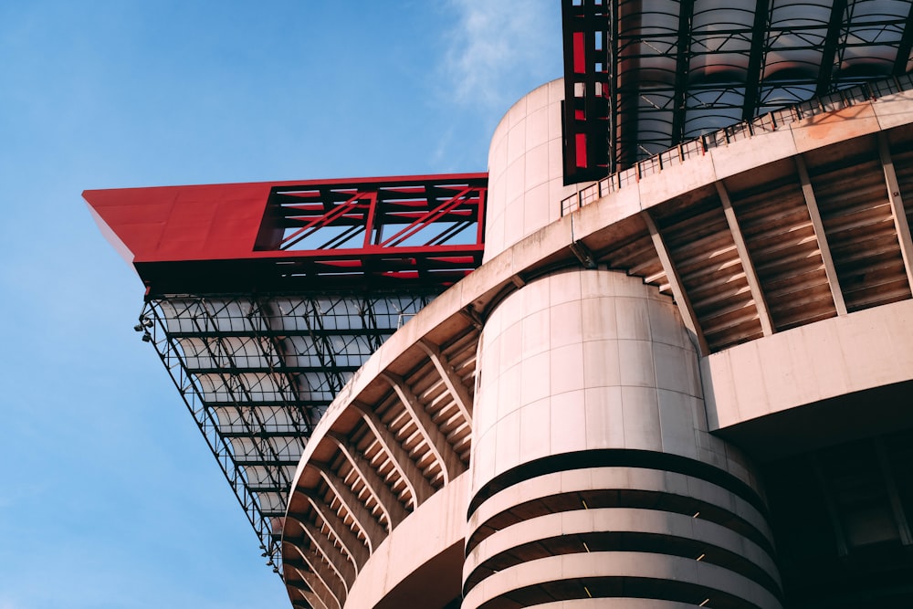 a tall building with a red roof under a blue sky