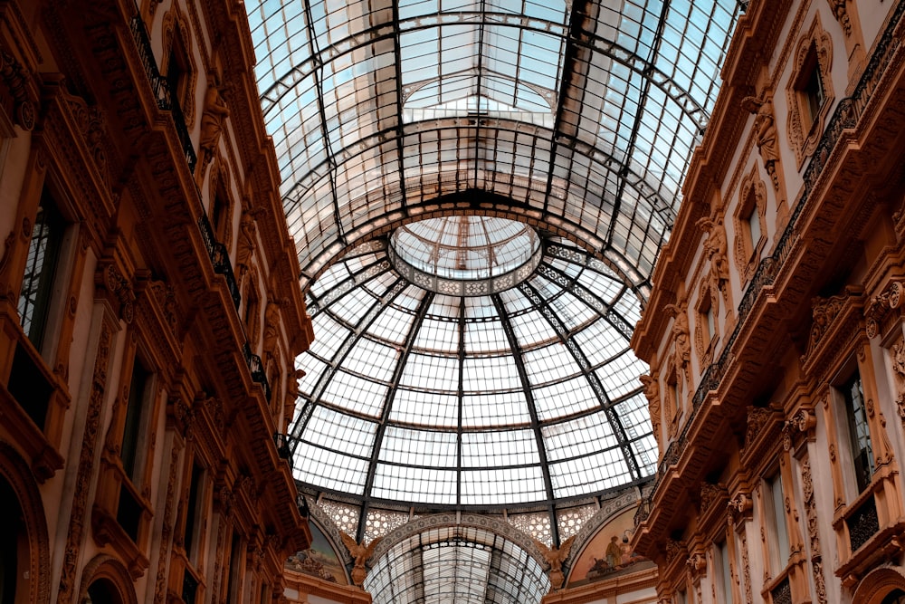 a building with a glass ceiling and a clock on it